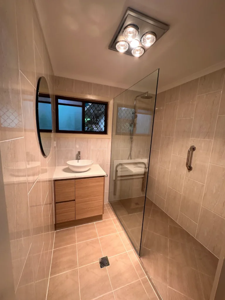 Floor to ceiling tiled, fitted with grab rails and shower sheet