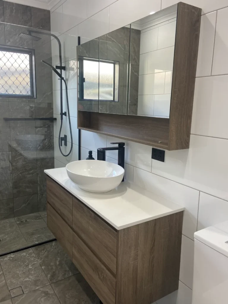 Grey and white tiled bathroom, finished off with timber look vanity and shaving cabinet